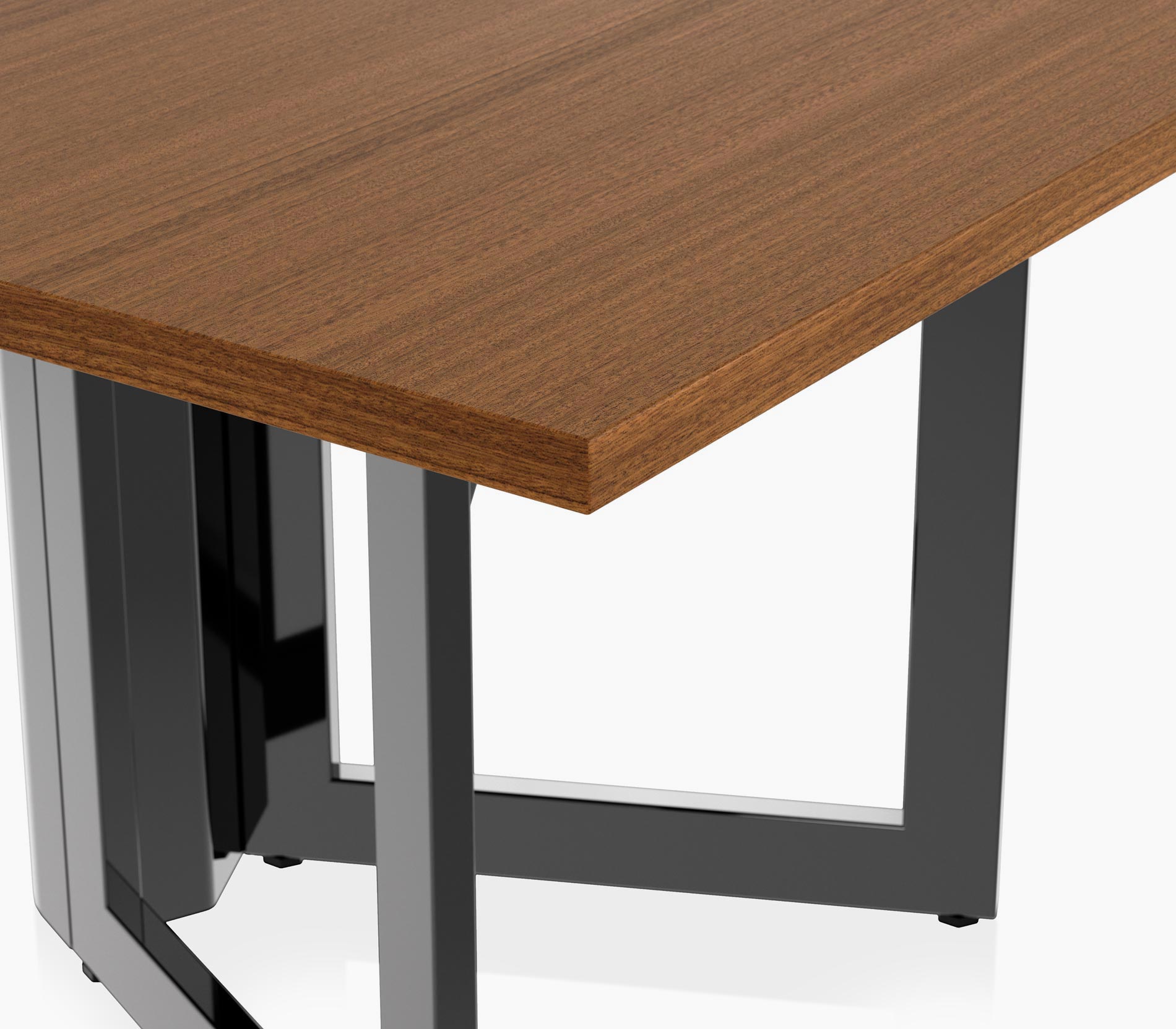 Edge detail on a Highline Vector Conference Table in natural quarter cut walnut with a jet black base