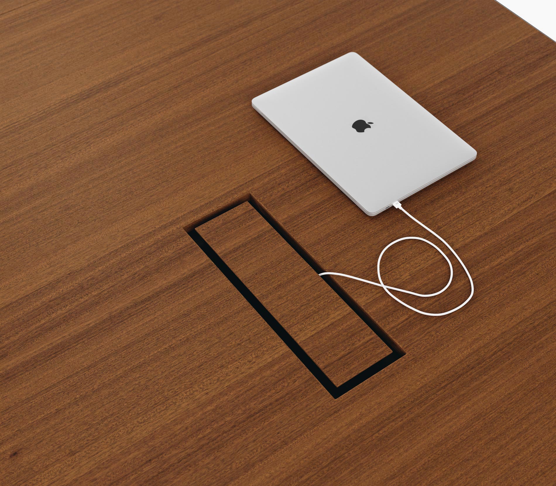 Tabletop power access on a Highline Vector Conference Table in natural quarter cut walnut