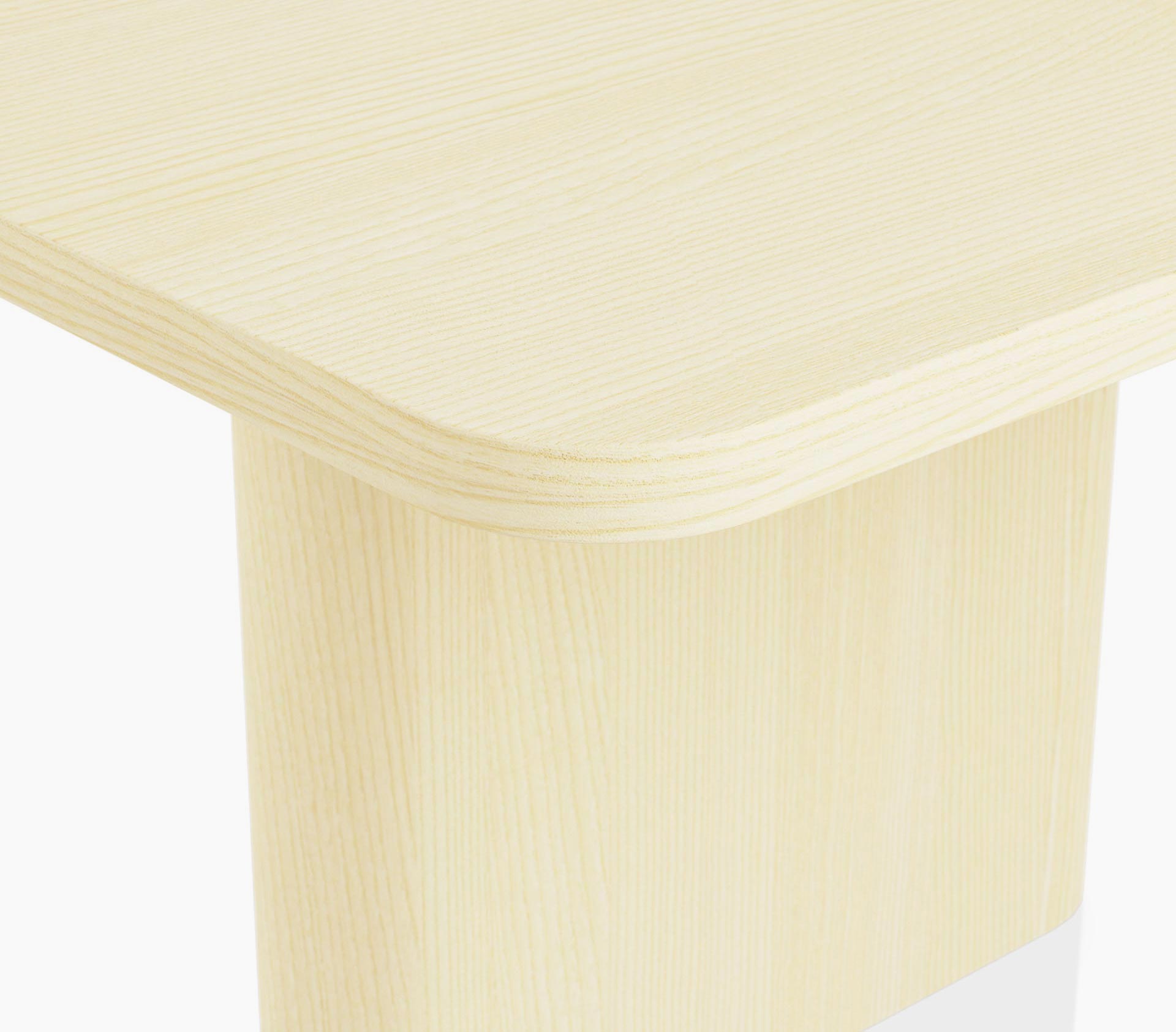 Edge detail on a rectangular JD Conference Table in white quarter cut ash with a 1.25” thick tabletop and a racetrack-shaped base
