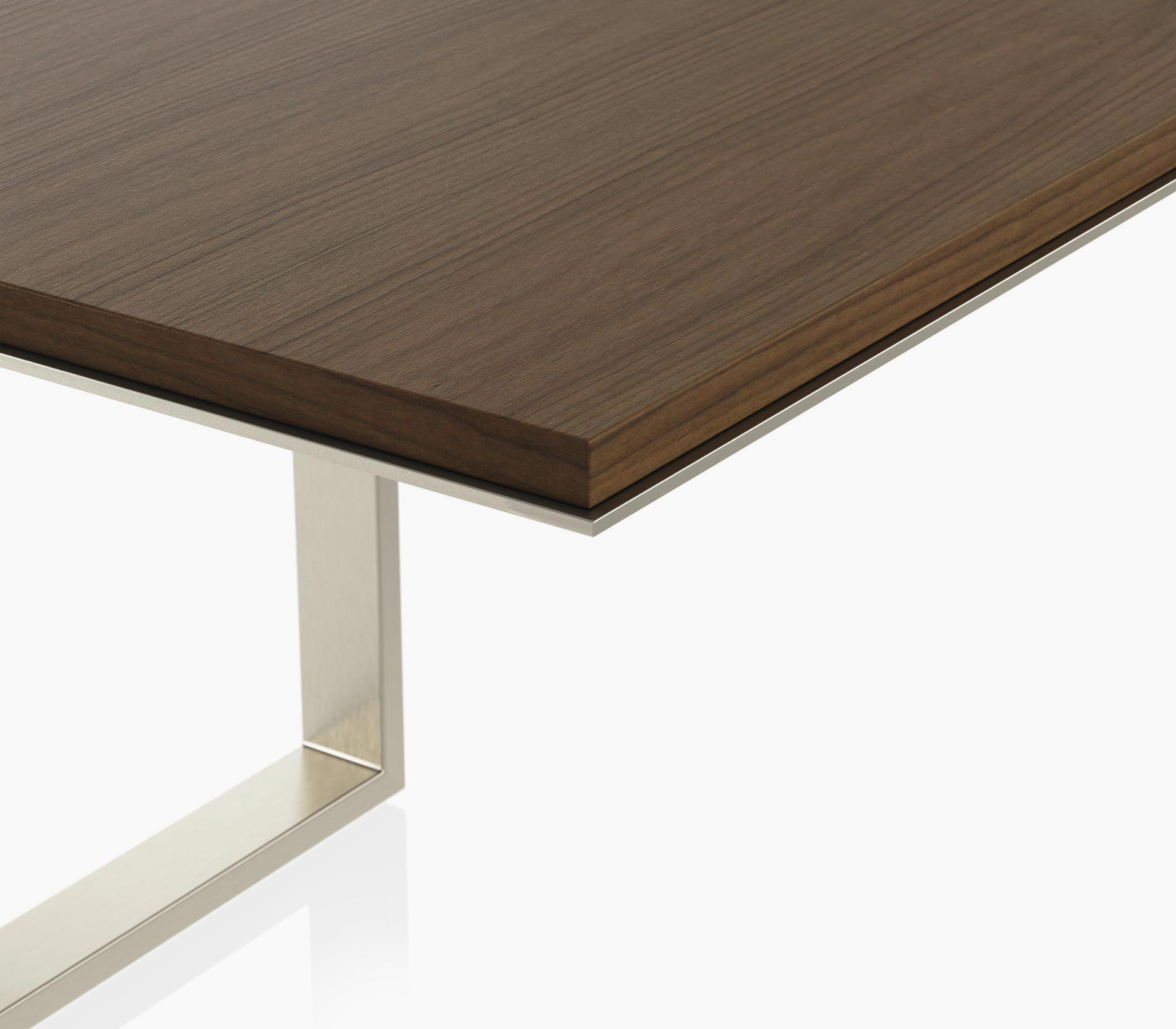 Edge detail on a Highline Conference Table in cashmere flat cut walnut with a satin nickel edge and base