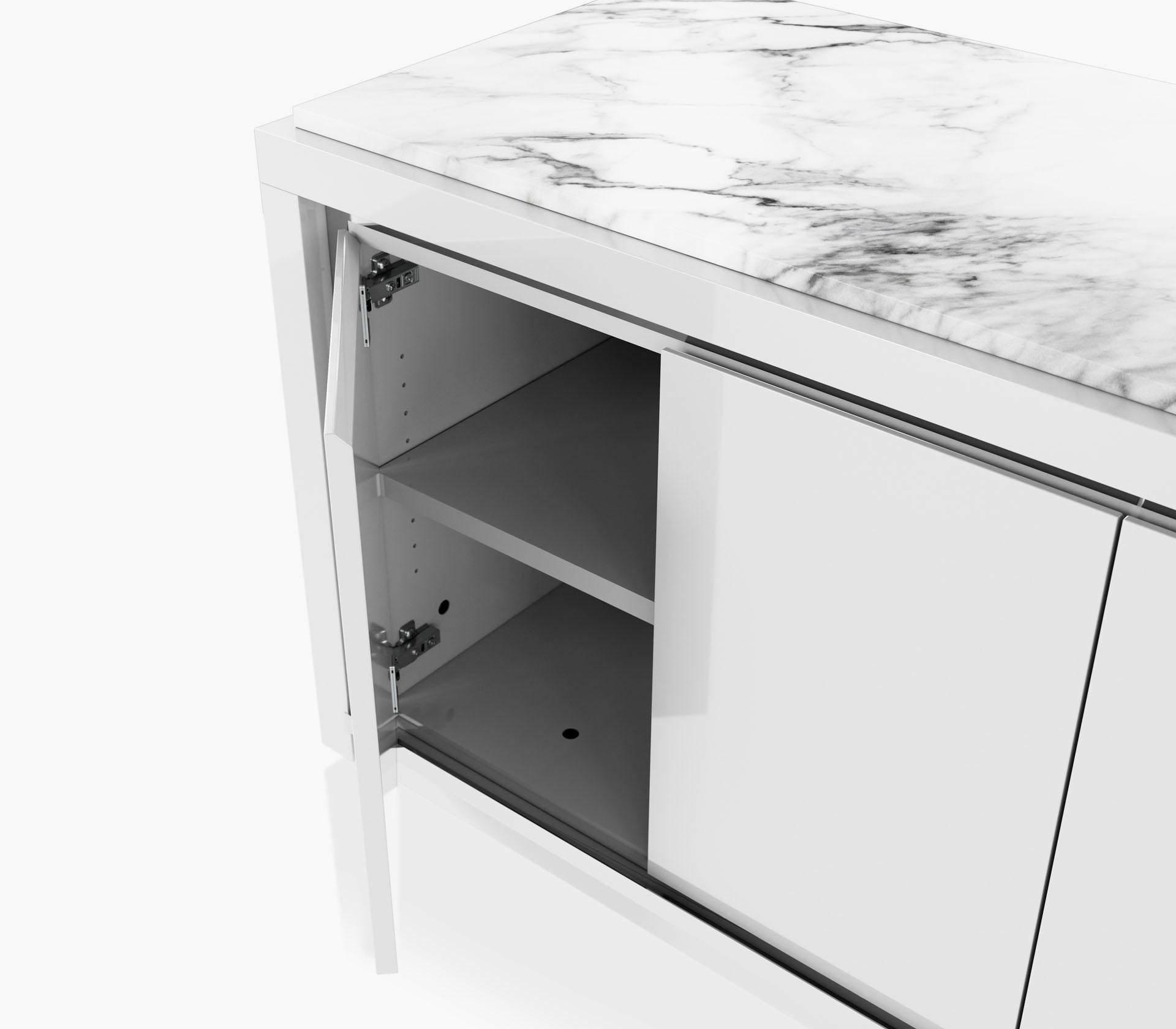 Open hinged door detail on a Highline Fifty Credenza in white polyester with a white carrara marble top and a polished chrome metal trim