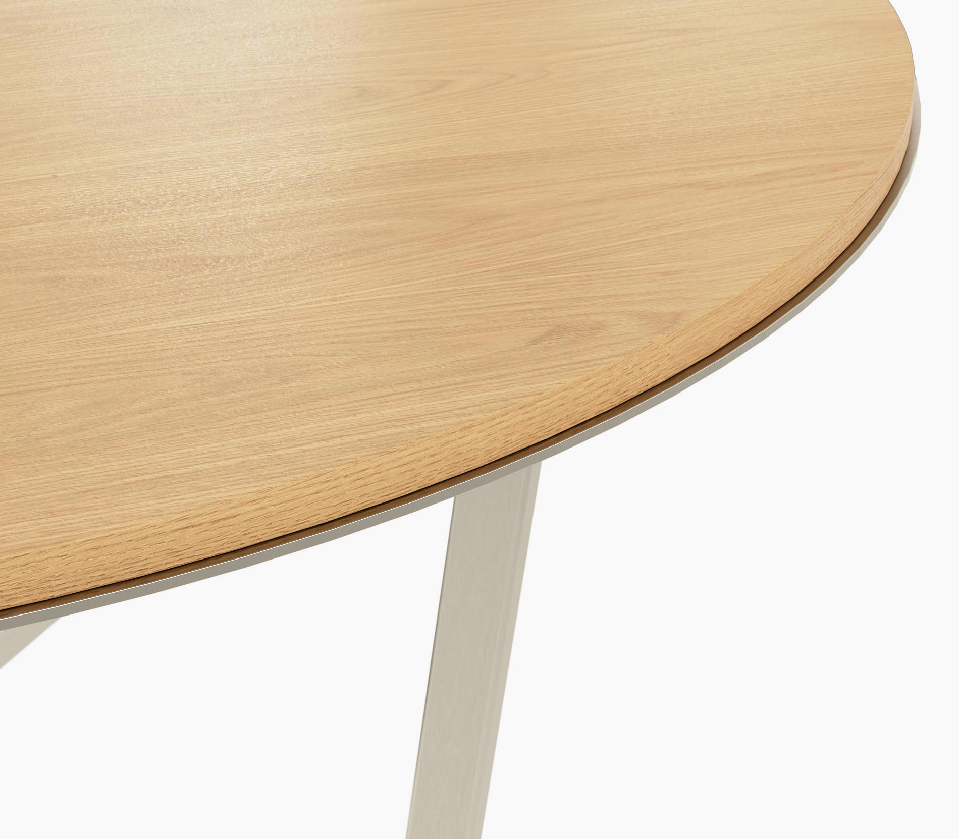Edge detail on a Circular Highline Meeting Table in natural flat cut oak with a satin nickel edge and base