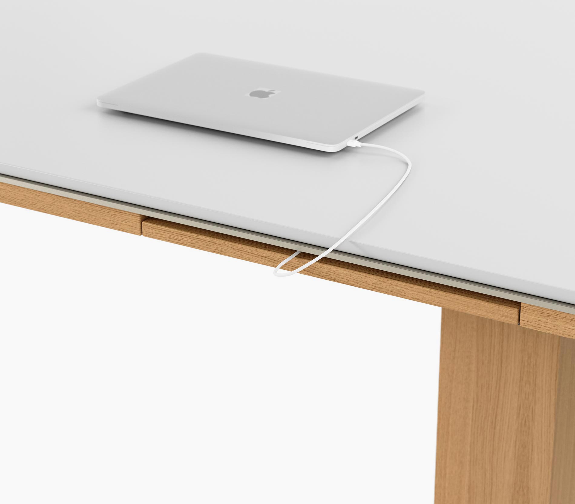 Closed power drawer on a Highline Fifty Conference Table in glacier white corian and natural rift cut oak, viewed from an angle